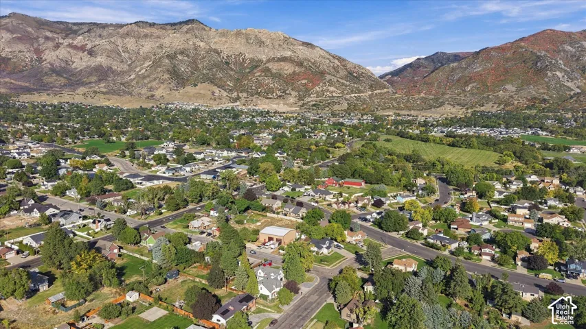 Expansive neighborhood setting with established homes, mature trees, and mountainous terrain