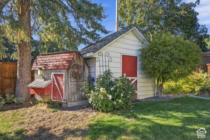 Manicured lawn, mature trees, and a wooden fence