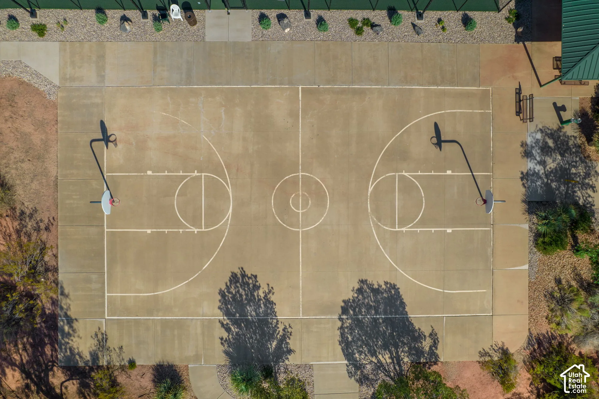 Outdoor basketball court with concrete surfacing and painted court lines