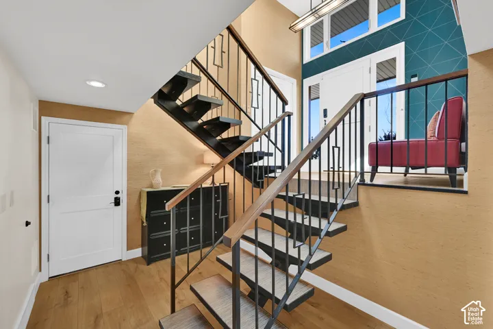 Custom Floating staircase with metal balusters and wood-handrails