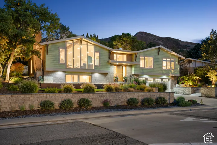 Contemporary-style exterior with expansive windows with gorgeous sunset views and professional landscape design throughout front and back