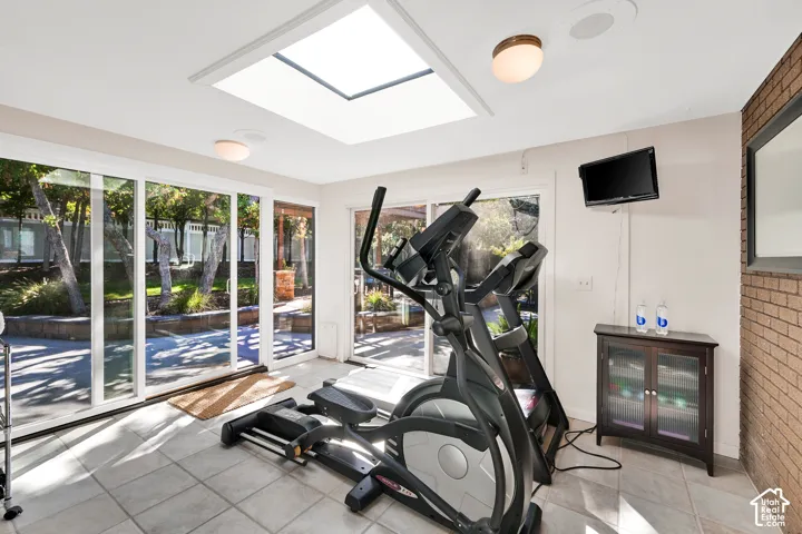 Recessed skylight and ceiling-mounted light fixtures illuminate the space and exercise equipment is included!