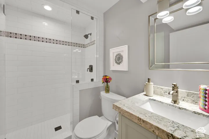 New Walk-in shower with clear glass enclosure and subway tile surround, accented by a decorative mosaic band