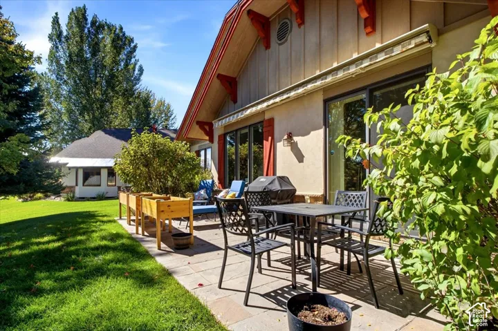 Stone paver patio featuring space and mature landscaping