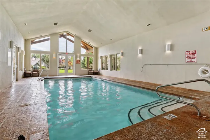 Community indoor pool featuring vaulted ceilings