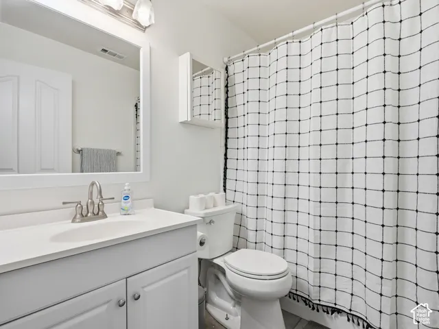 White vanity with an integrated sink and brushed nickel faucet