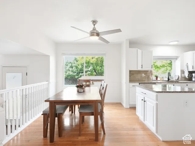 Hardwood flooring extending through the dining area and kitchen