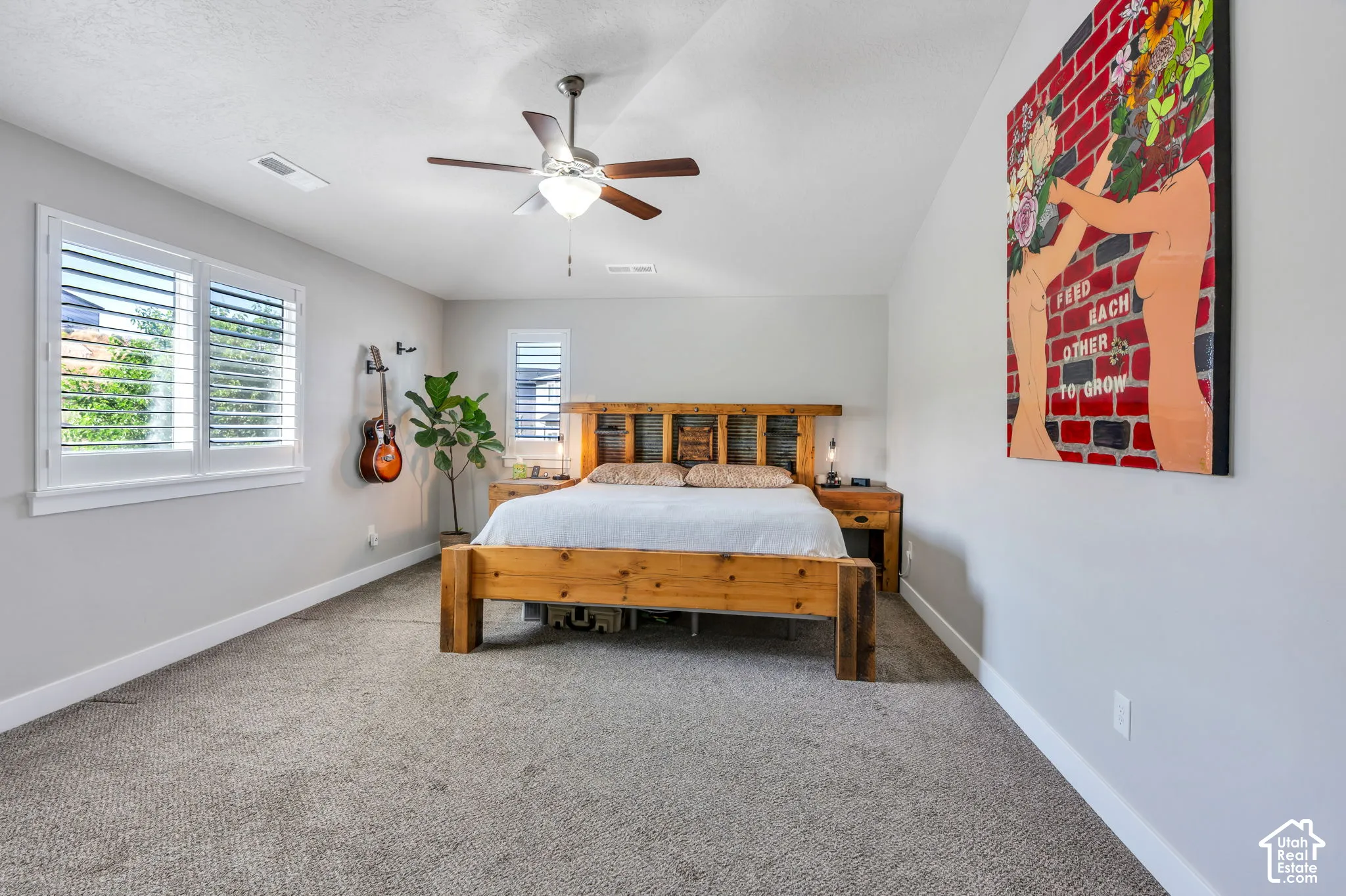 Carpeted flooring, white plantation shutters, a ceiling fan with integrated lighting, and light gray wall paint