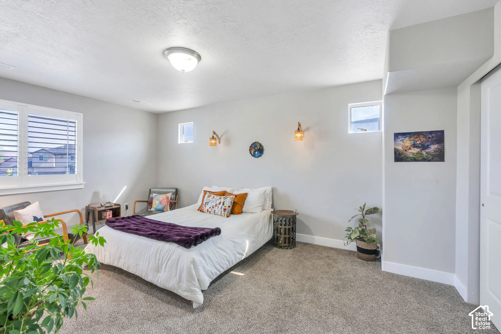 Carpeted flooring, recessed lighting, and multiple windows with white blinds