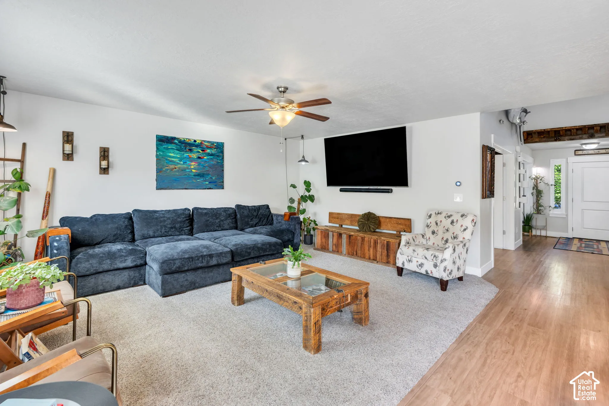 Wood-finish flooring, ceiling fan, and recessed wall lighting features