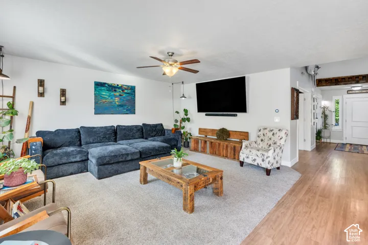 Wood-finish flooring, ceiling fan, and recessed wall lighting features