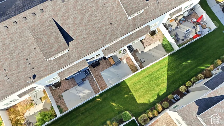Private backyard featuring a paved patio area, an additional gravel patio, and a manicured lawn