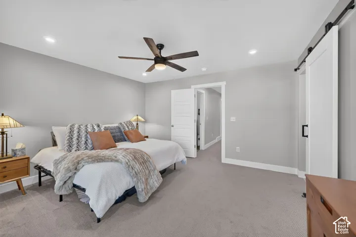 Recessed lighting, wood-finish ceiling fan, light gray wall paint, and gray carpeting