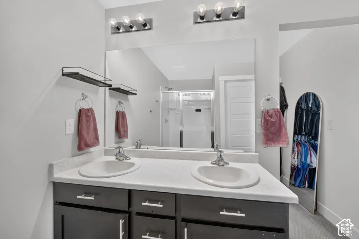 Dual vanity with integral sinks, light-toned countertop, and dark wood-finish cabinetry