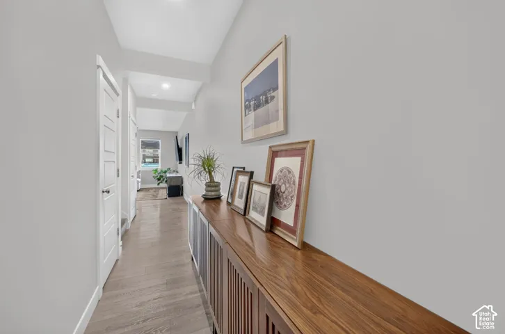 Hallway featuring wood-finish flooring and recessed lighting