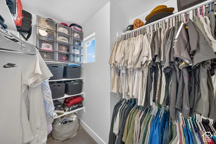 Built-in closet shelving system with hanging rods and a window