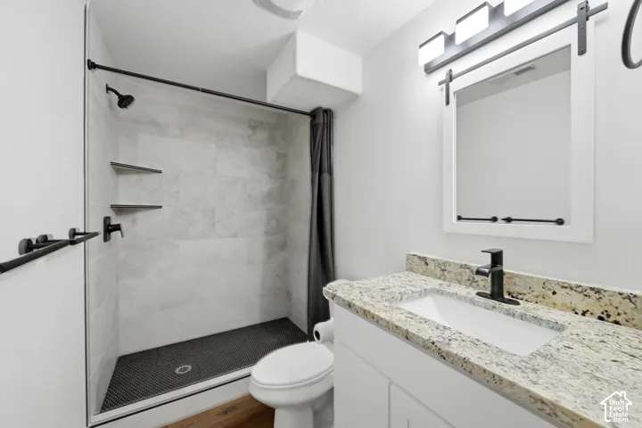 Walk-in shower with tiled walls and matte black fixtures
