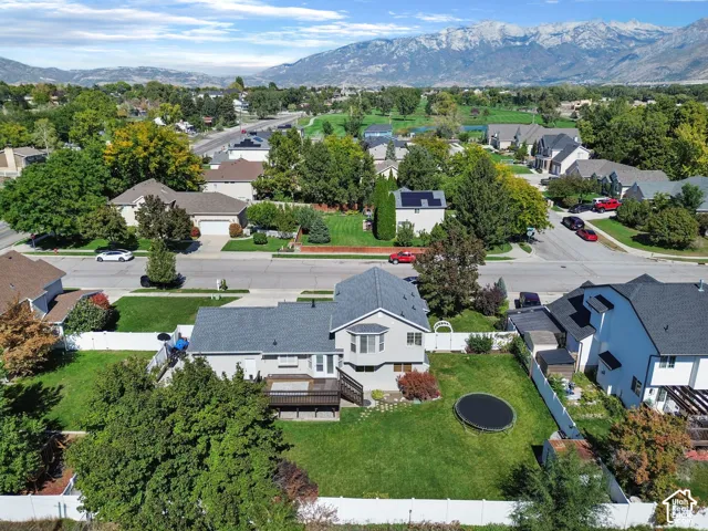 Expansive backyard featuring a manicured lawn, multi-level deck, and mature trees