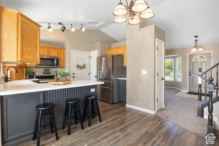 Kitchen with wood-finish flooring, white countertops, and NEW stainless steel appliances