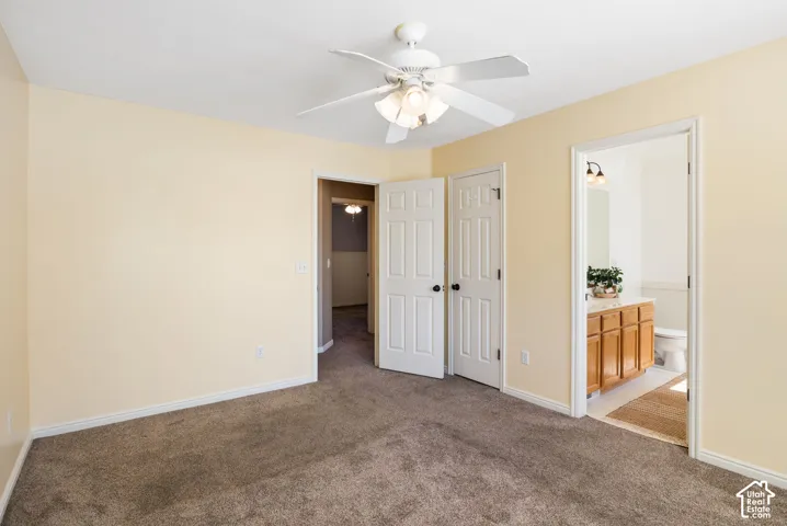 Primary Bedroom. Carpeted room with a ceiling fan light fixture