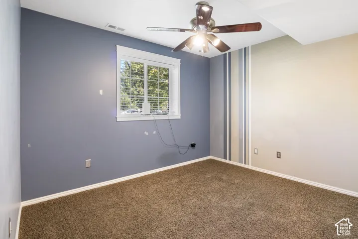 Wall-to-wall carpeting, white trim, and window with horizontal blinds