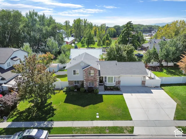 Two-story residence featuring a brick and siding exterior, a two-car garage, and a concrete driveway