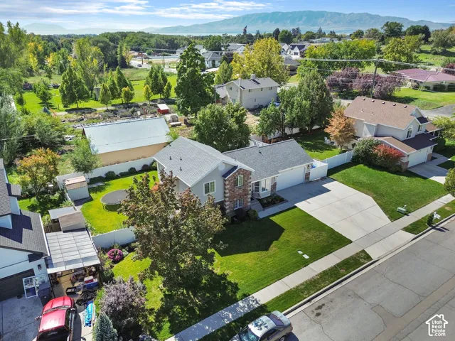 Single-family residence with an attached two-car garage, concrete driveway, and a fenced backyard featuring a storage shed