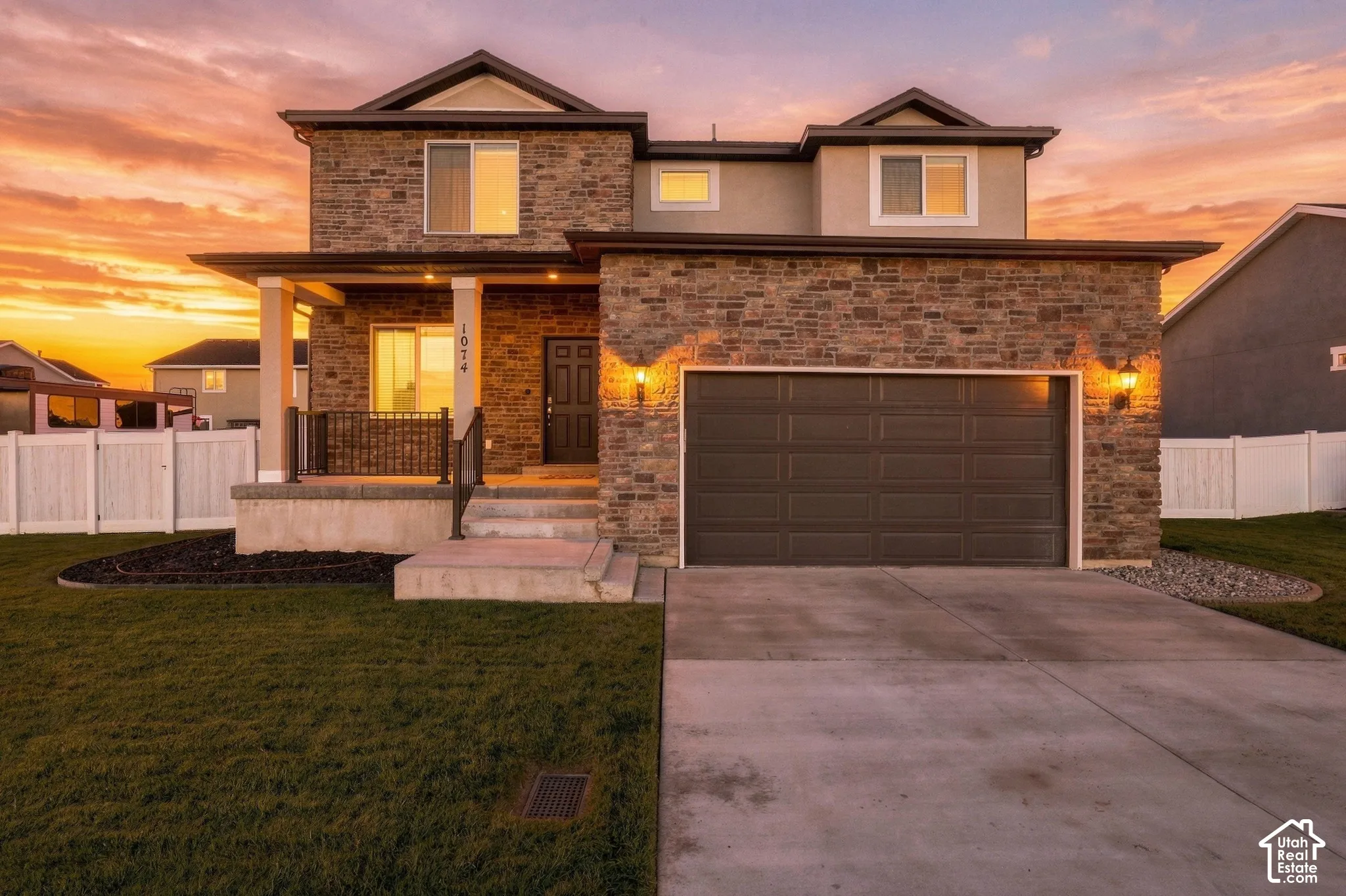 Stone and stucco exterior with an integrated two-car garage