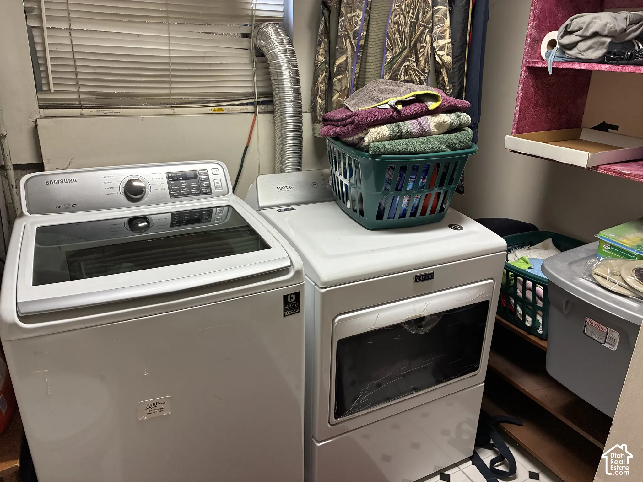 Laundry area featuring a top-load washing machine, front-load dryer, and wall-mounted shelving