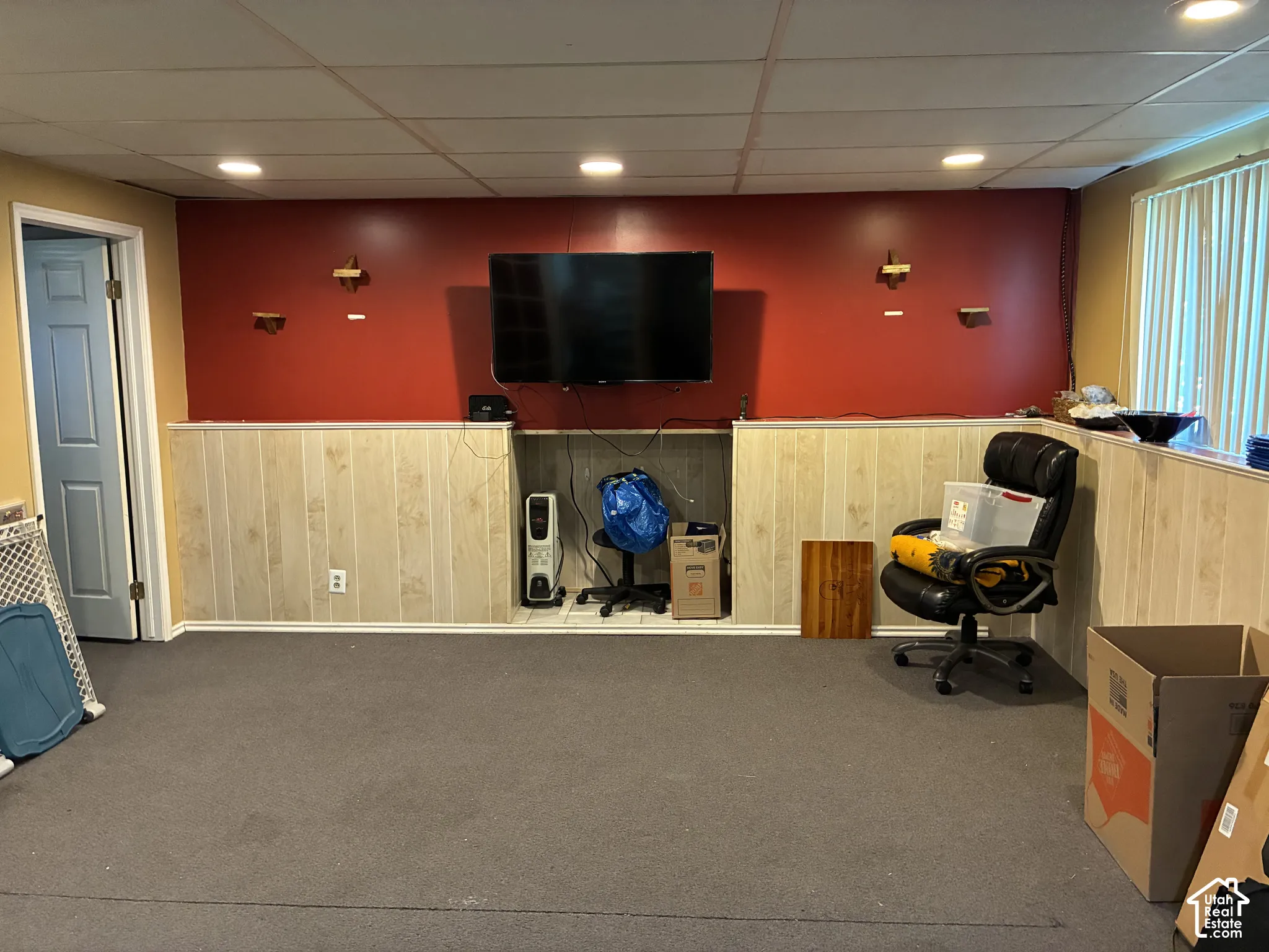 Recessed lighting, drop ceiling, wainscoting, built-in media niche, and light-filtering window treatments