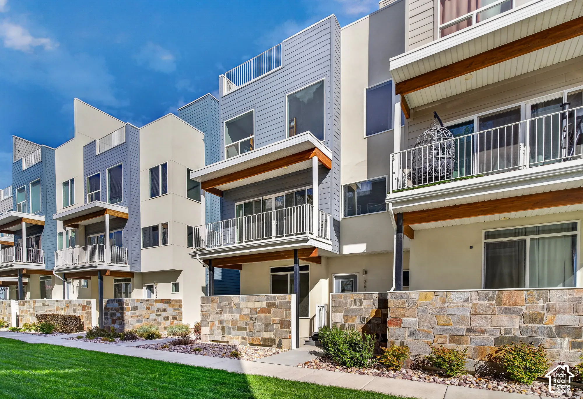 Modern multi-level townhome architecture with flat roofs