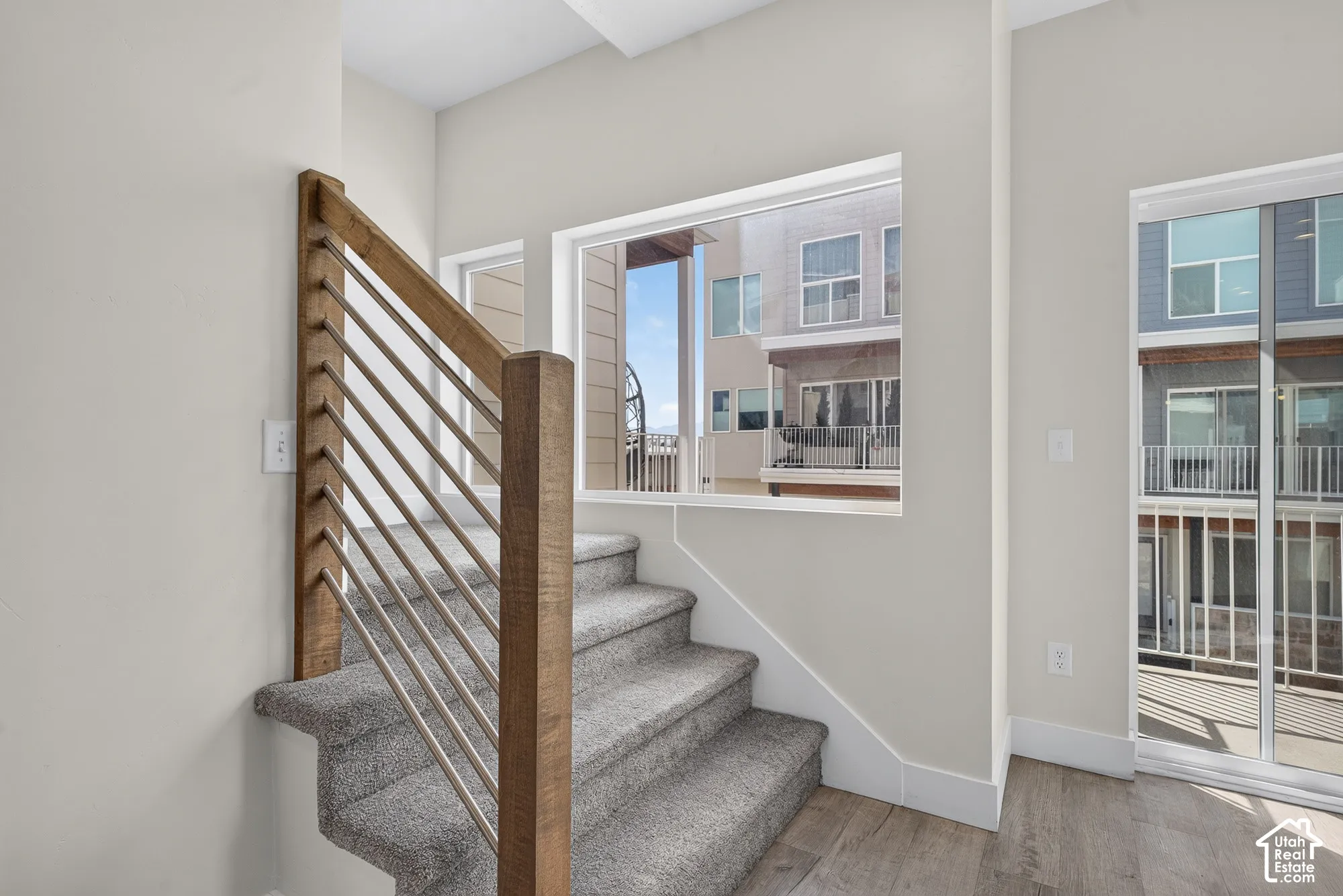 Modern staircase with wood-finish newel posts and horizontal metal balusters