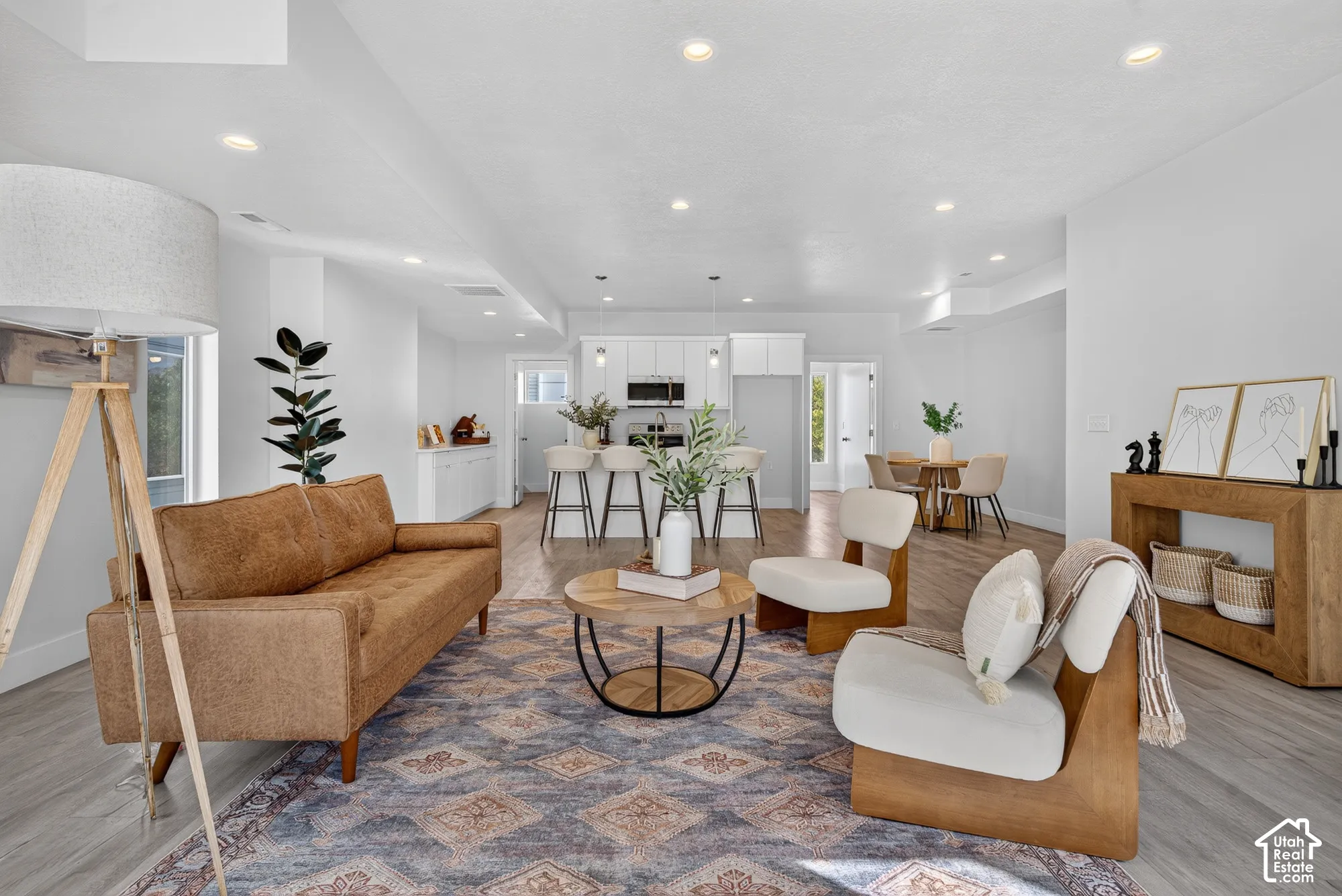 Open concept living area featuring recessed lighting and wood-finish flooring