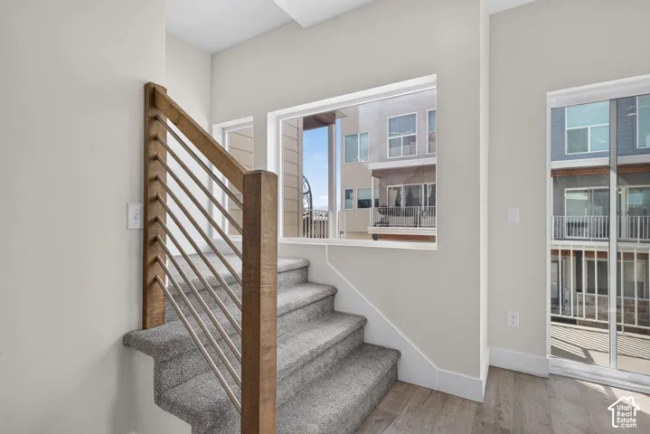 Modern staircase with wood-finish newel posts and horizontal metal balusters