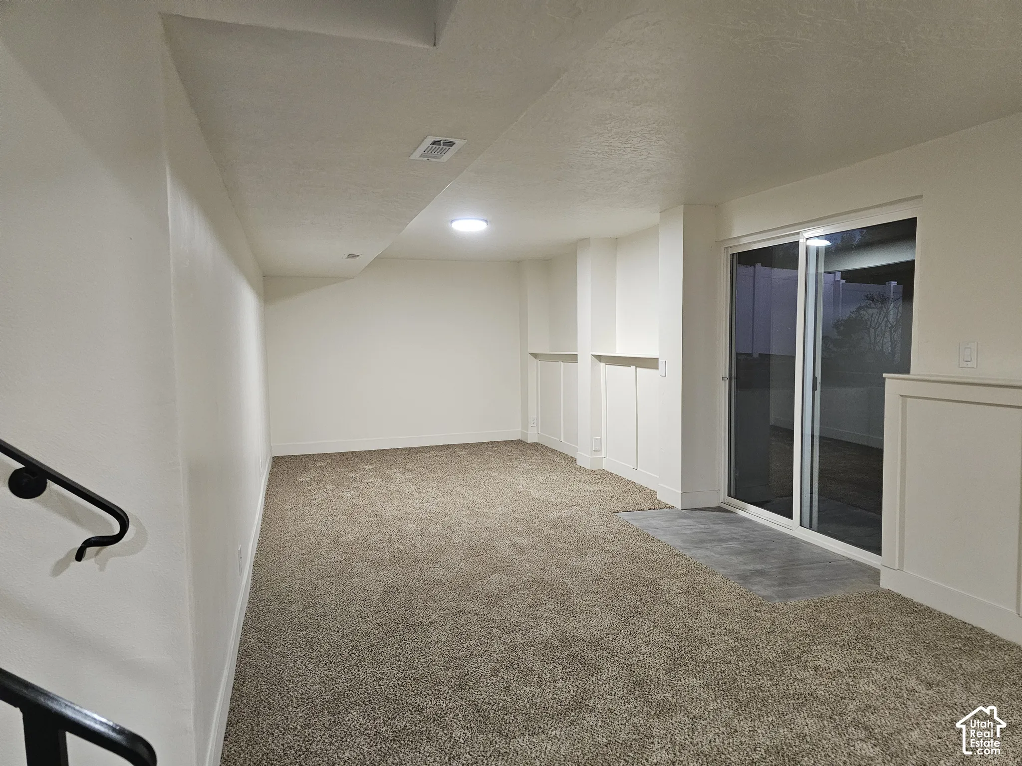 View of the Family Room from the bottom of the stairs