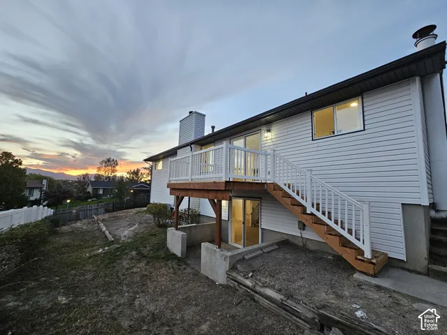 View of the back side of the house, deck, patio, and back yard area