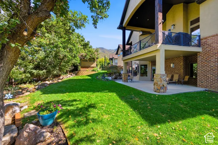 Manicured lawn with mature trees and stone landscaping
