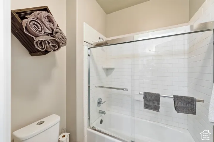 Tub/shower combination with subway tile surround and sliding glass enclosure