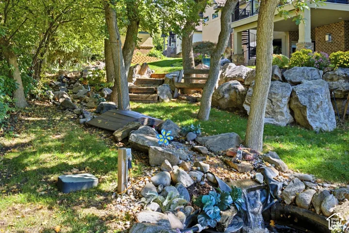Cascading water feature with natural rockery and mature trees