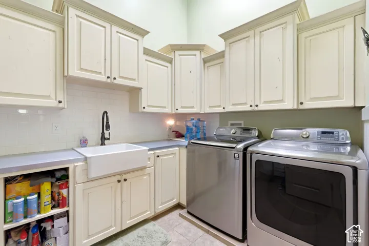 White subway tile backsplash, farmhouse-style sink, matte black faucet, light-toned cabinetry, and integrated open shelving