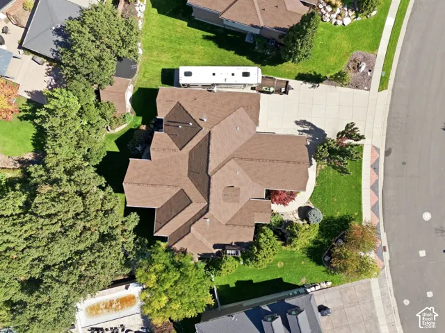 Expansive property featuring a multi-gabled roof, mature landscaping, and a substantial driveway