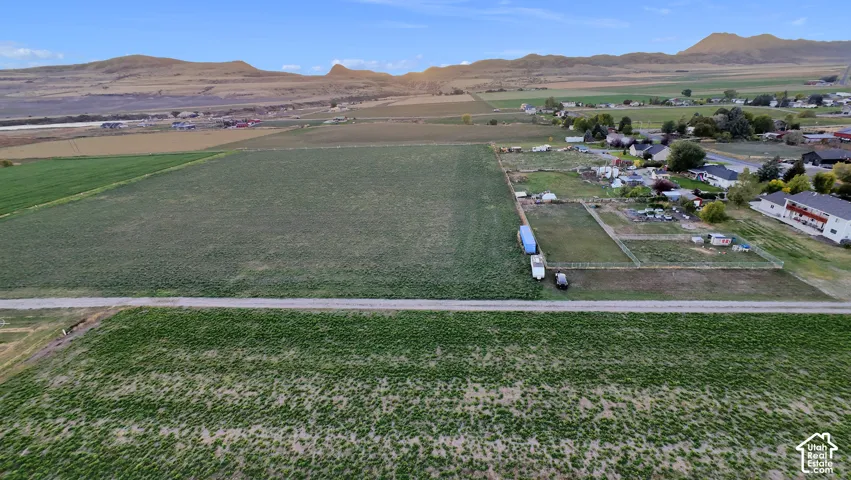 Expansive fields with a distant mountain range backdrop
