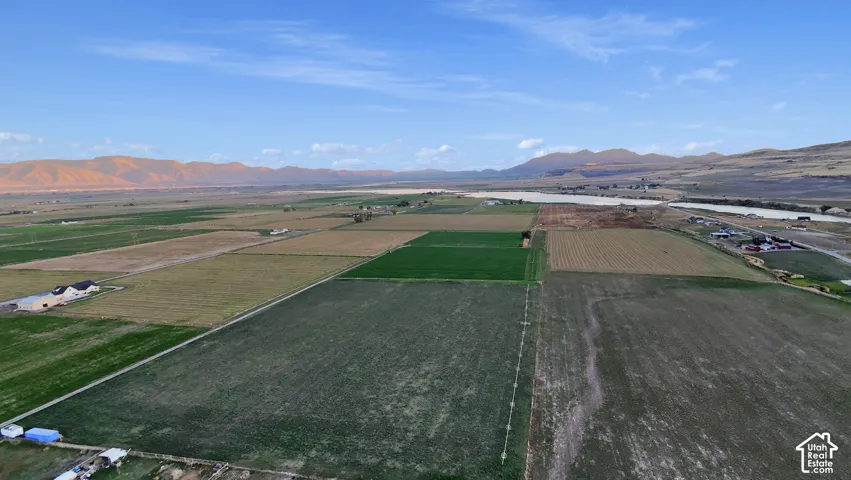 Expansive agricultural fields with distant mountain backdrop
