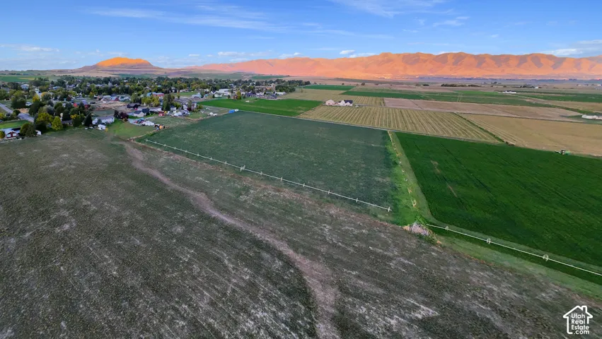 Expansive land parcel featuring cultivated fields and a distant mountain range