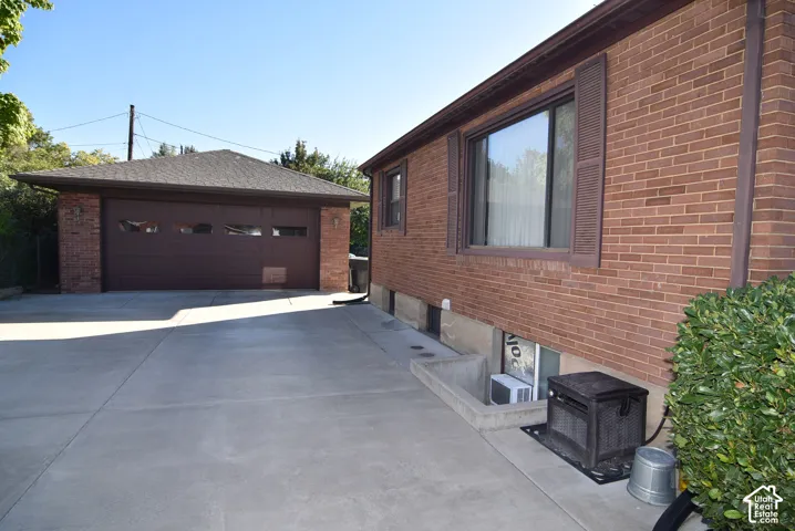 Brick exterior with a large window and louvered shutters