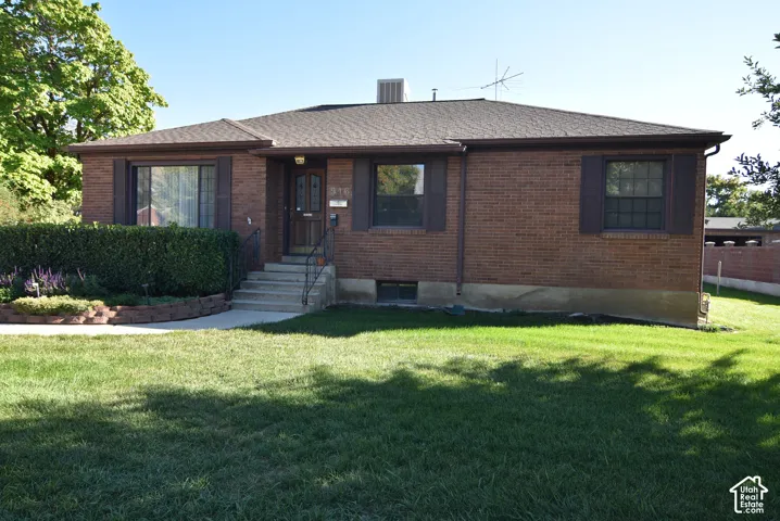 Brick exterior with a gabled roof and dark window shutters