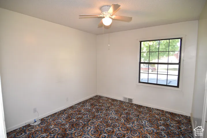 Bedroom #1 Ceiling fan with light fixture, window with grid panes, wall-to-wall carpeting