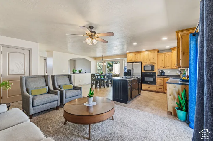 Open-concept living area with carpeted flooring
