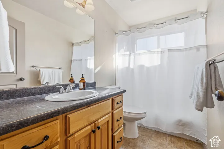 Light wood-finish vanity with a built-in sink and dark countertop