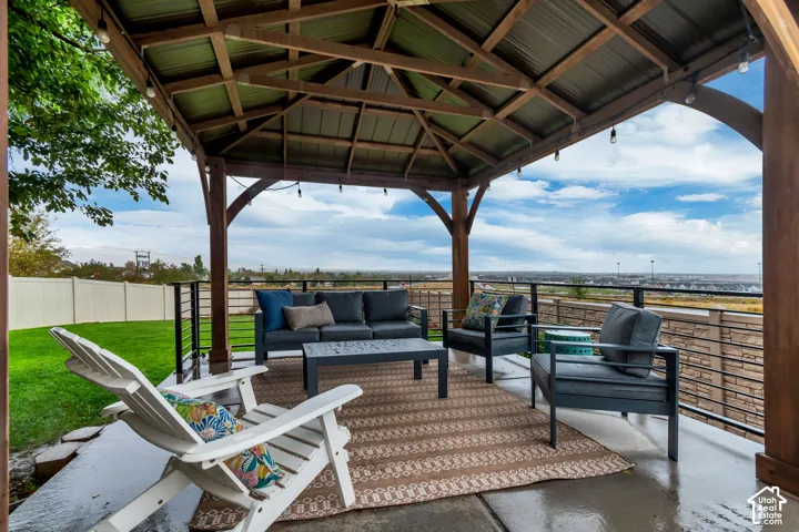 Covered patio with a wood-frame gazebo and corrugated metal roof